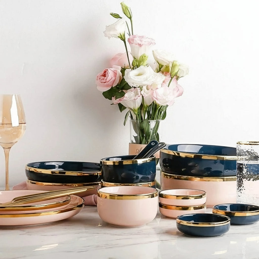 Pink, black, and gold inlay ceramic dinnerware set by MC The Black Diamond, featuring elegant plates and bowls on a white background.