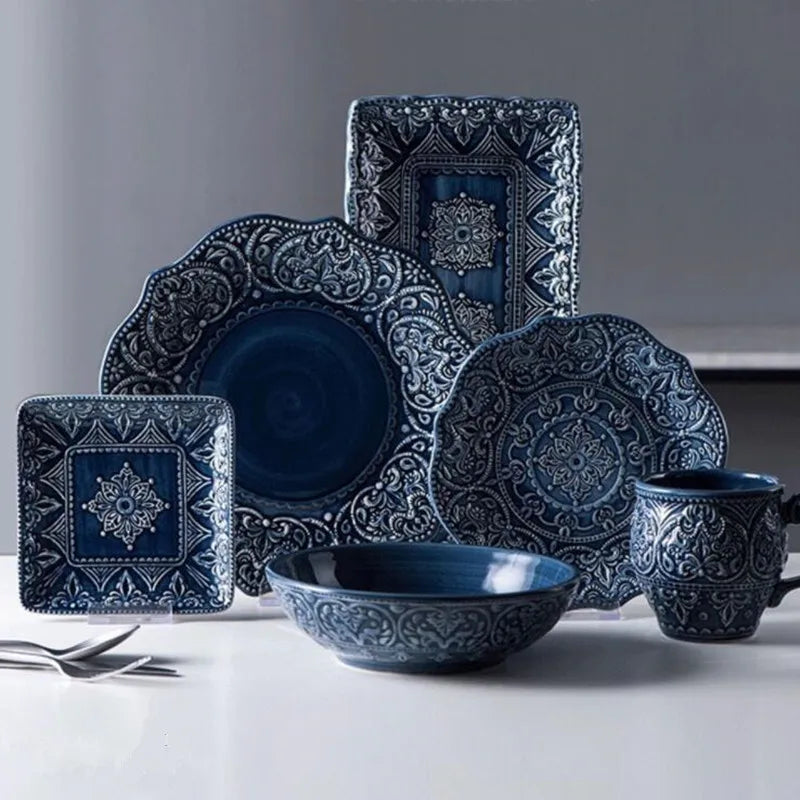 Blue retro relief ceramic dinnerware set by MC THE BLACK DIAMOND, featuring matching plates and bowls with vintage-style design.