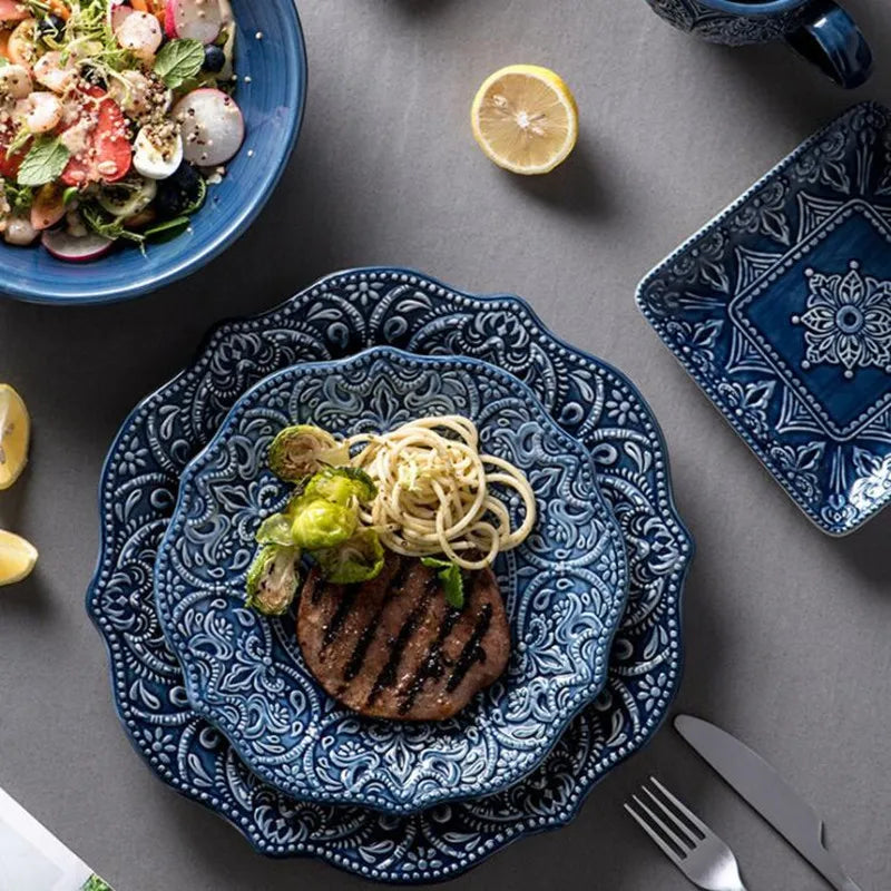 Blue retro relief ceramic dinnerware set by MC THE BLACK DIAMOND, featuring matching plates and bowls with vintage-style relief designs.