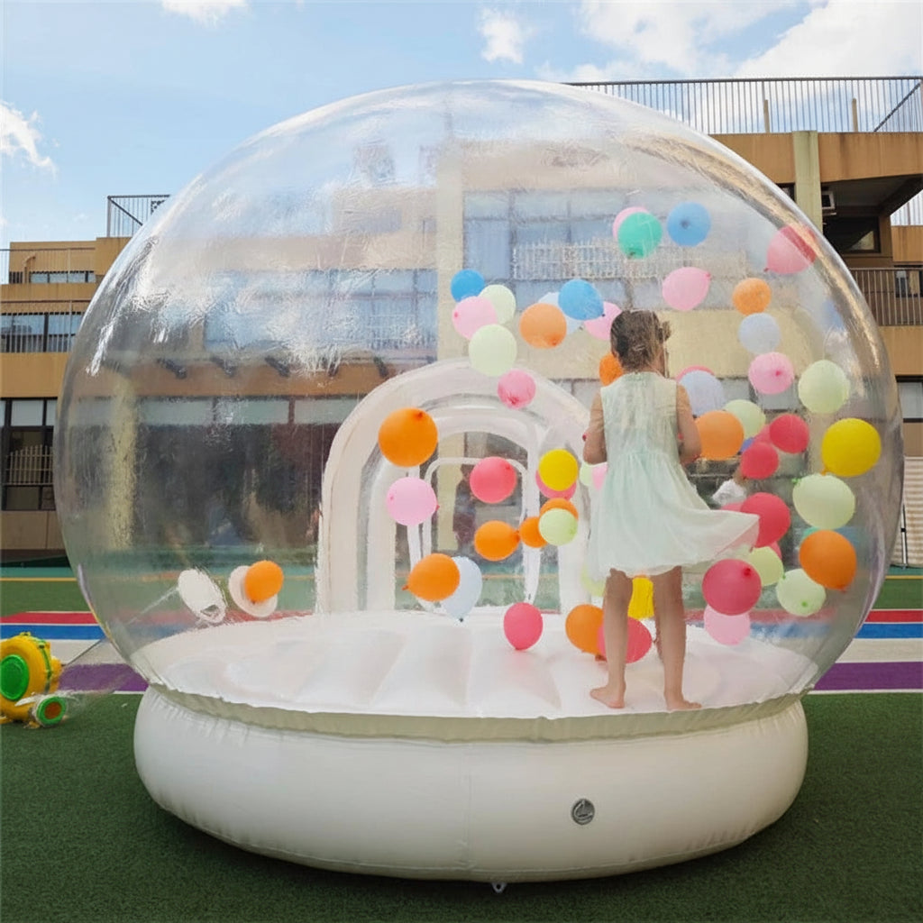Transparent inflatable crystal dome bubble room used as an inflatable bouncer by MC THE BLACK DIAMOND, with clear plastic walls and rounded shape.