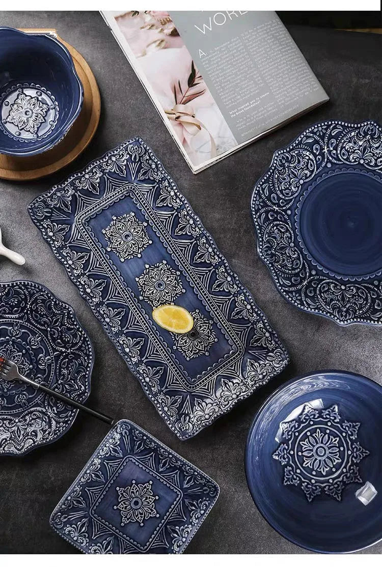Blue retro relief ceramic dinnerware set by MC THE BLACK DIAMOND, featuring matching plates and bowls with textured design.