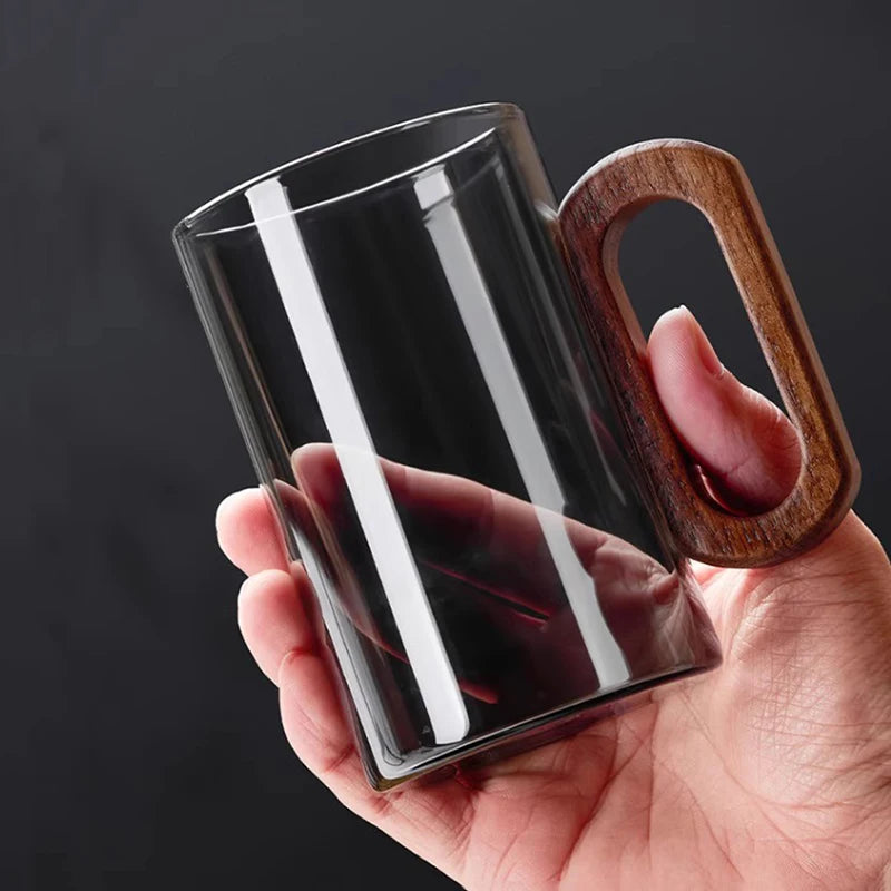 Glass mug with wooden handle from MC The Black Diamond drinkware set, designed for hot beverages, showcasing a clear glass and wooden handle.