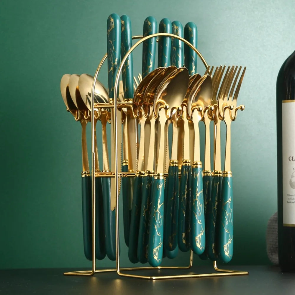 Stainless steel flatware set by MC THE BLACK DIAMOND with forks, knives, and spoons arranged on a table.
