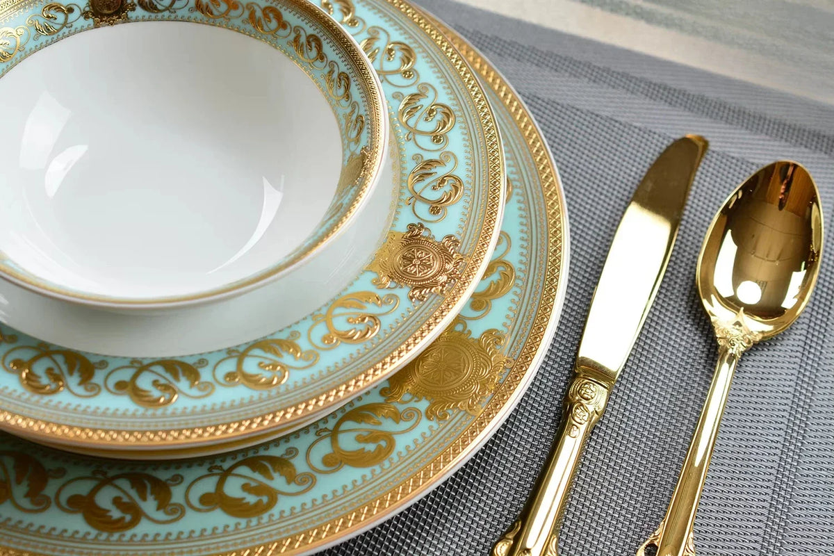 Embossed gold porcelain dinnerware set by MC THE BLACK DIAMOND with elegant embossed patterns on plates and bowls.
