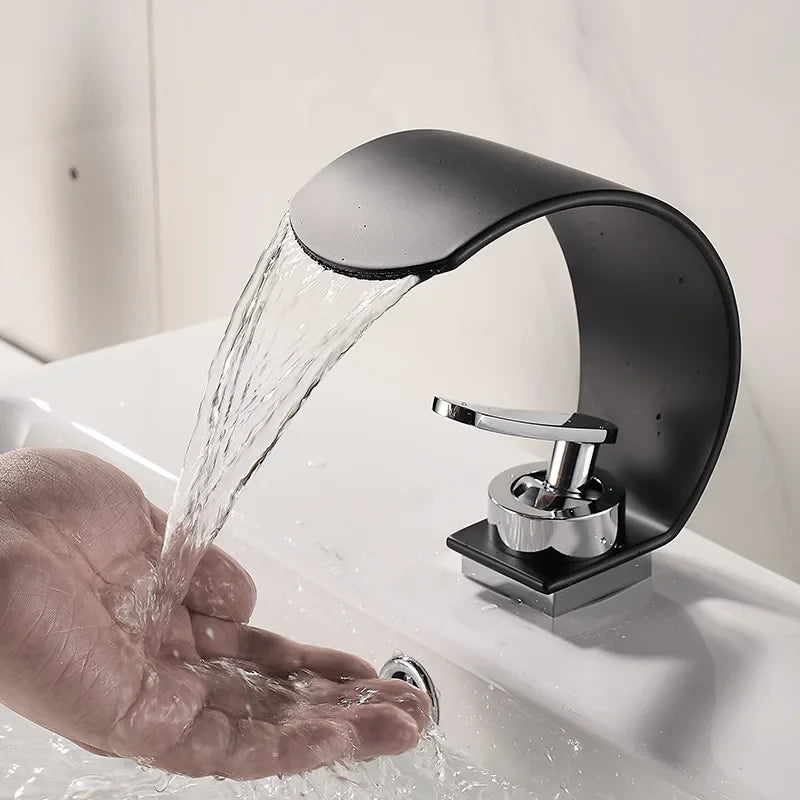 Black and white hot and cold water hydrant iron bathroom sink tap by MC THE BLACK DIAMOND, shown mounted on a bathroom sink.