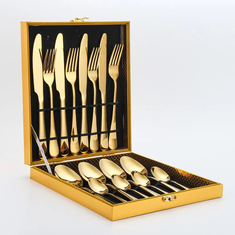 Golden MC THE BLACK DIAMOND flatware set with cutlery dishes, featuring sleek, polished utensils and matching serving dishes.