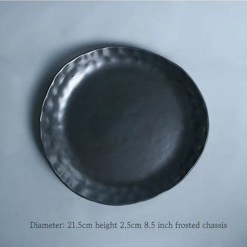 Deep black MC THE BLACK DIAMOND family dinner set with plates, bowls, and mugs arranged on a dining table.