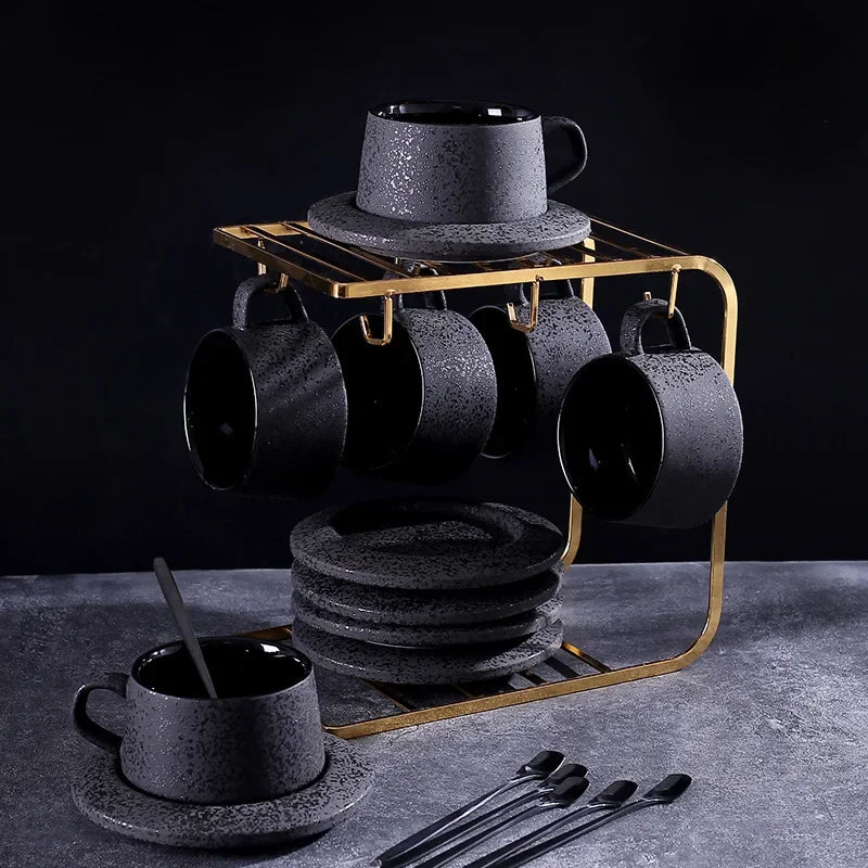 Black ceramic coffee cup and saucer set with spoon and cup holder, part of MC THE BLACK DIAMOND coffee and tea sets.