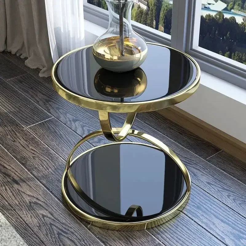 Modern stainless steel round end table with glass top by MC THE BLACK DIAMOND, featuring a sleek center design and contemporary style.