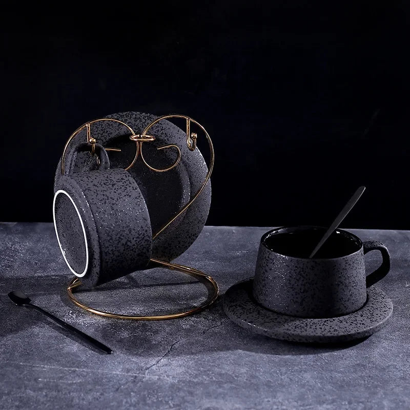 Black ceramic coffee cup and saucer set with spoon and cup holder, part of MC THE BLACK DIAMOND coffee and tea sets.