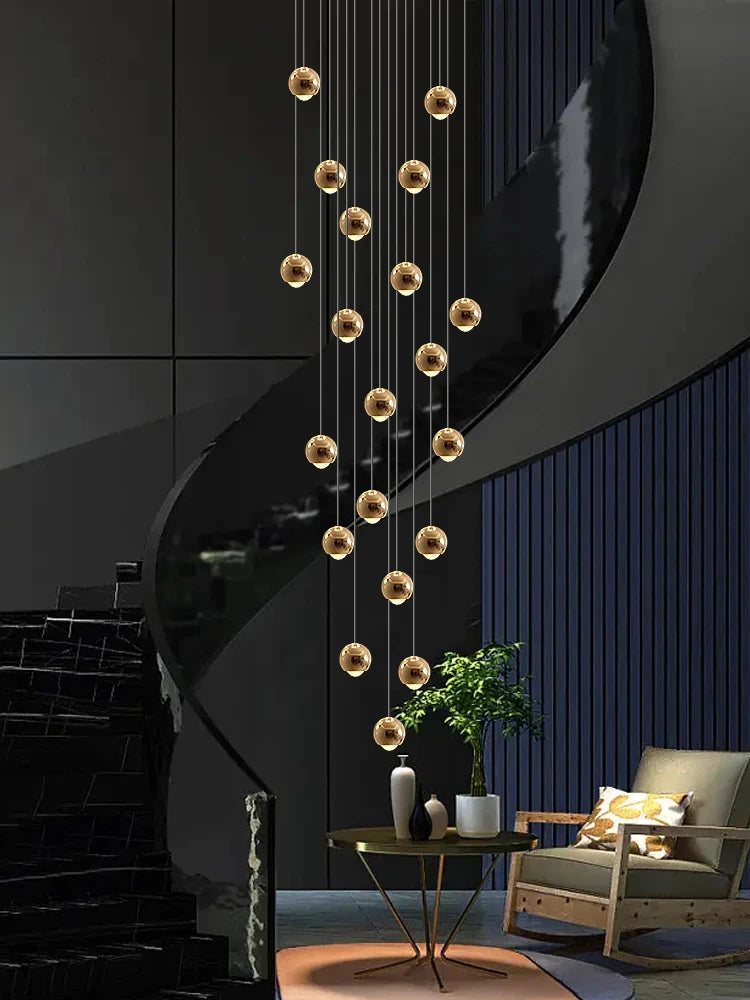 Modern MC THE BLACK DIAMOND LED staircase pendant light hanging in a living room, showcasing sleek design and bright illumination.