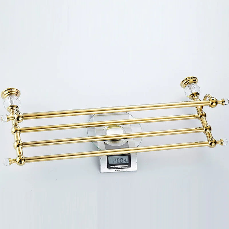 Luxury gold polished brass bathroom accessories set by MC THE BLACK DIAMOND, includes soap dispenser, toothbrush holder, and tumbler.