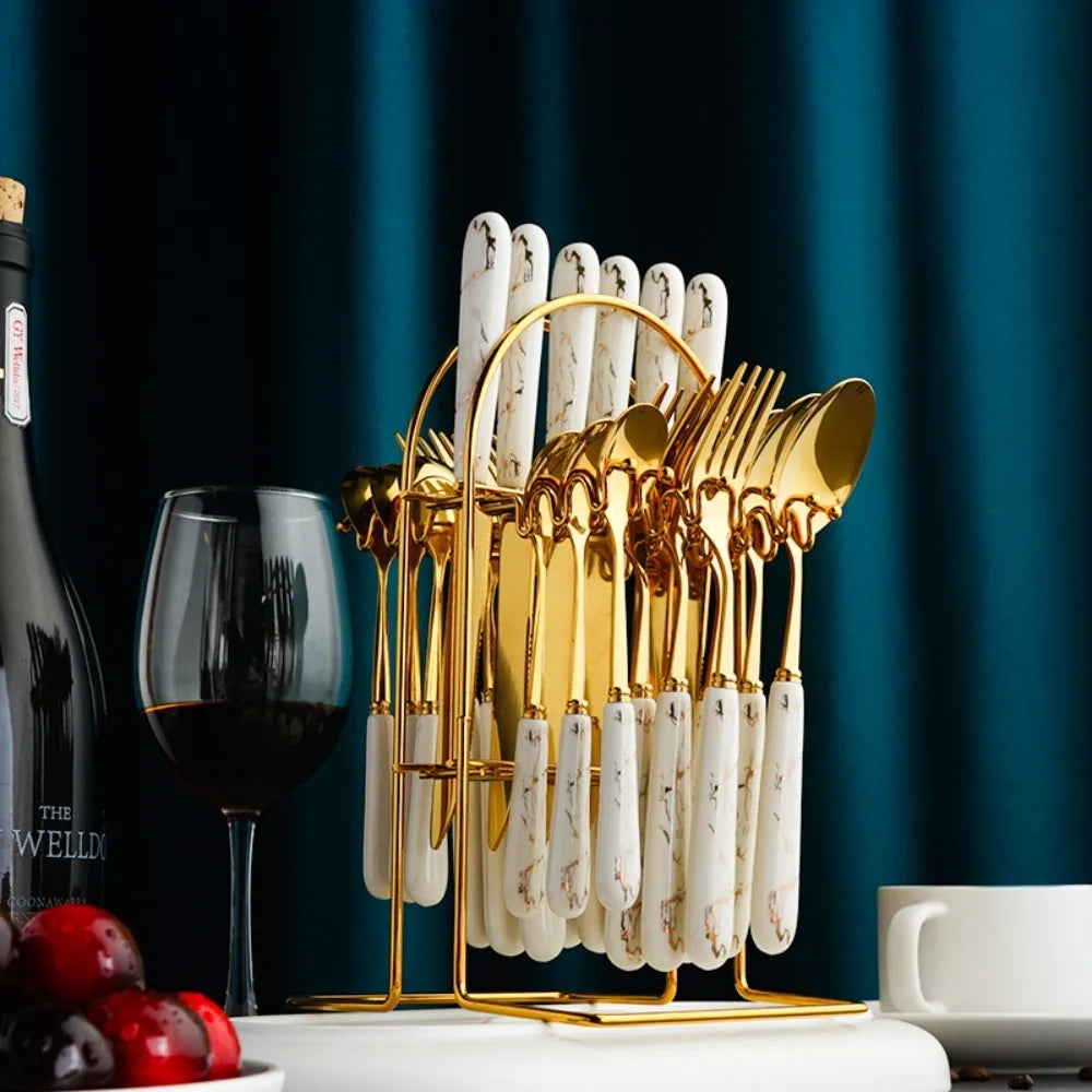 Stainless steel flatware set from MC THE BLACK DIAMOND, includes forks, knives, and spoons arranged on a table.