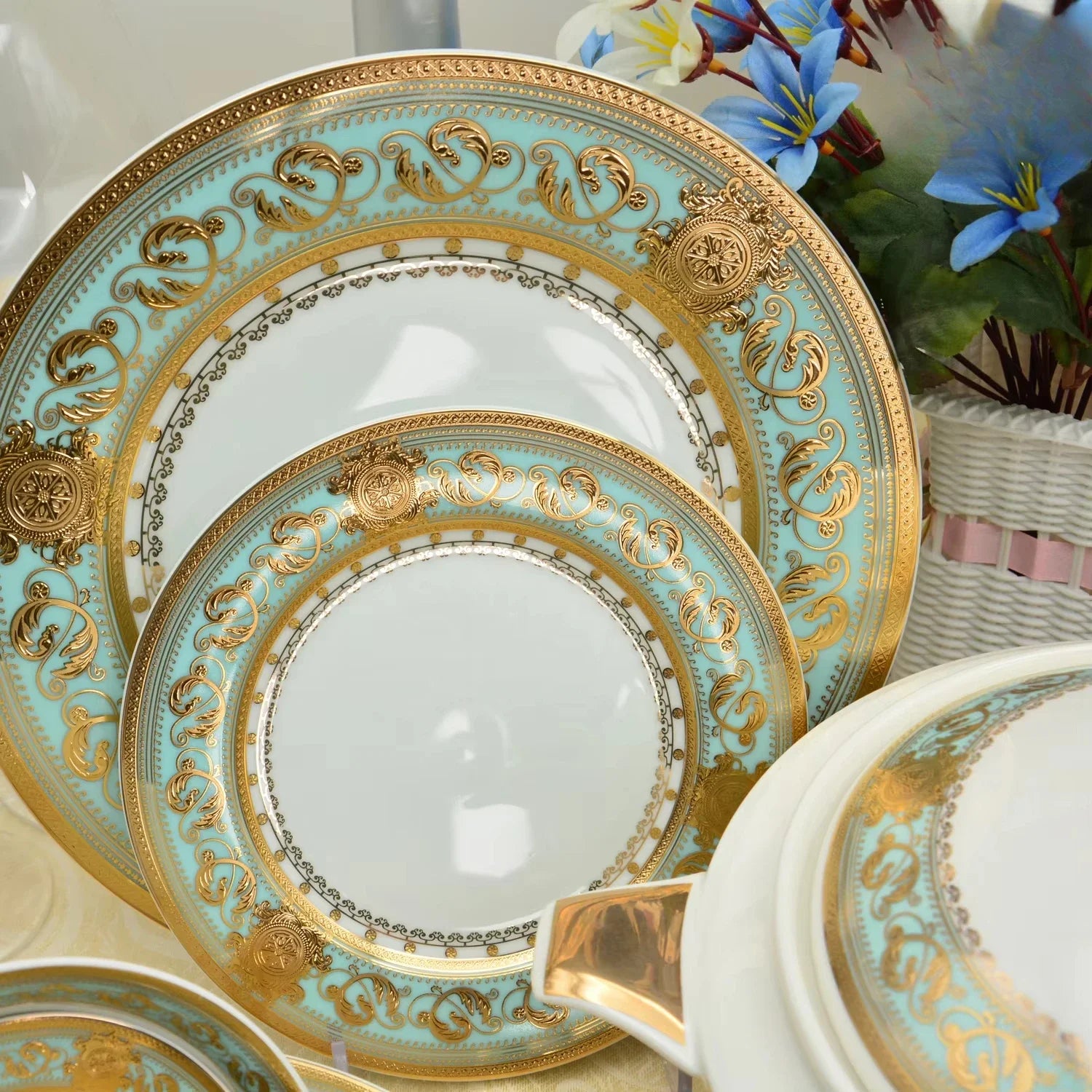 Gold embossed porcelain dinnerware set by MC THE BLACK DIAMOND, featuring elegant plates and bowls with intricate designs.