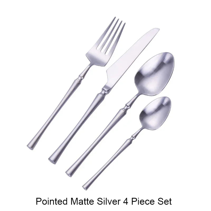 Matte stainless steel dinnerware set with black, gold, and silver finishes, featuring elegant, reflective surfaces and modern design.
