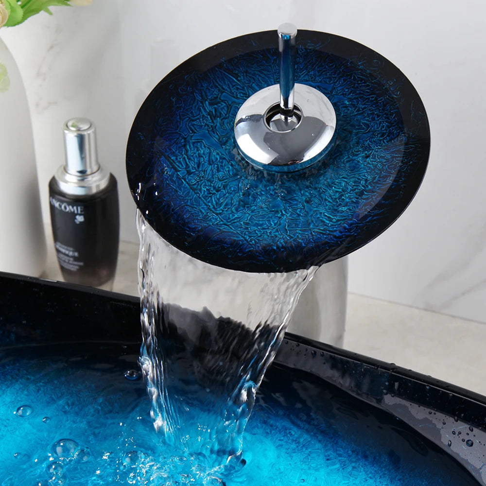 Blue glass vessel sink and waterfall faucet set by MC THE BLACK DIAMOND, showcasing the sleek glass basin and modern faucet design.