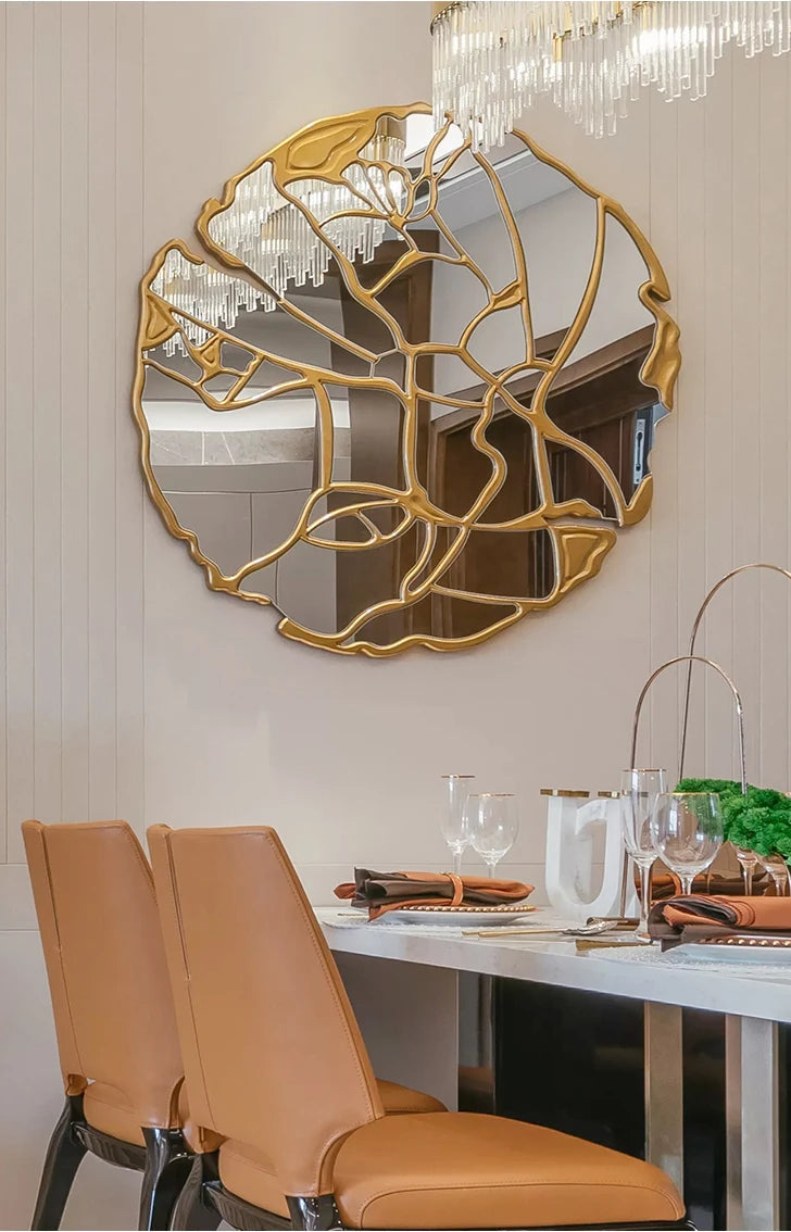 Round hand mirror from MC THE BLACK DIAMOND, used as stylish room decor and light reflection in home interior decoration.