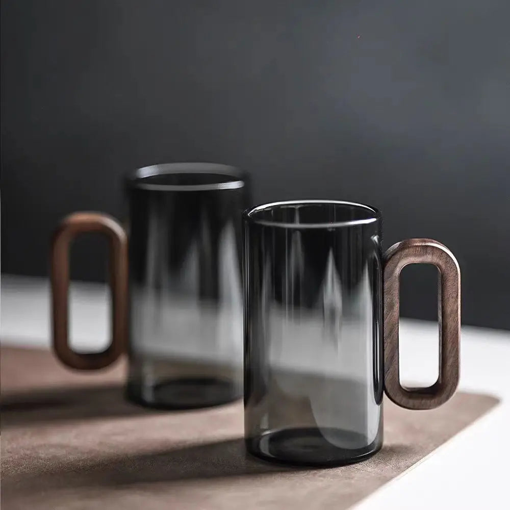 Glass mug with wooden handle from MC The Black Diamond drinkware set, designed for hot beverages, showcasing a stylish and sturdy design.