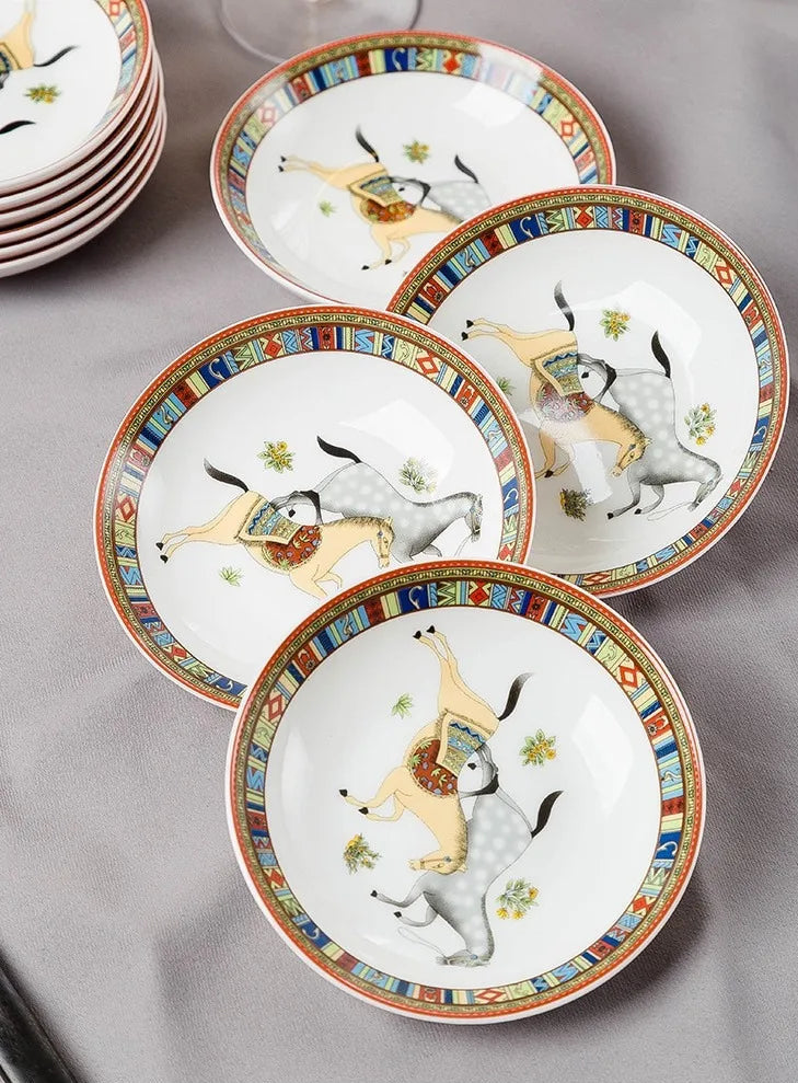 Ceramic dinnerware family size set by MC THE BLACK DIAMOND, includes plates, bowls, and mugs arranged on a dining table.