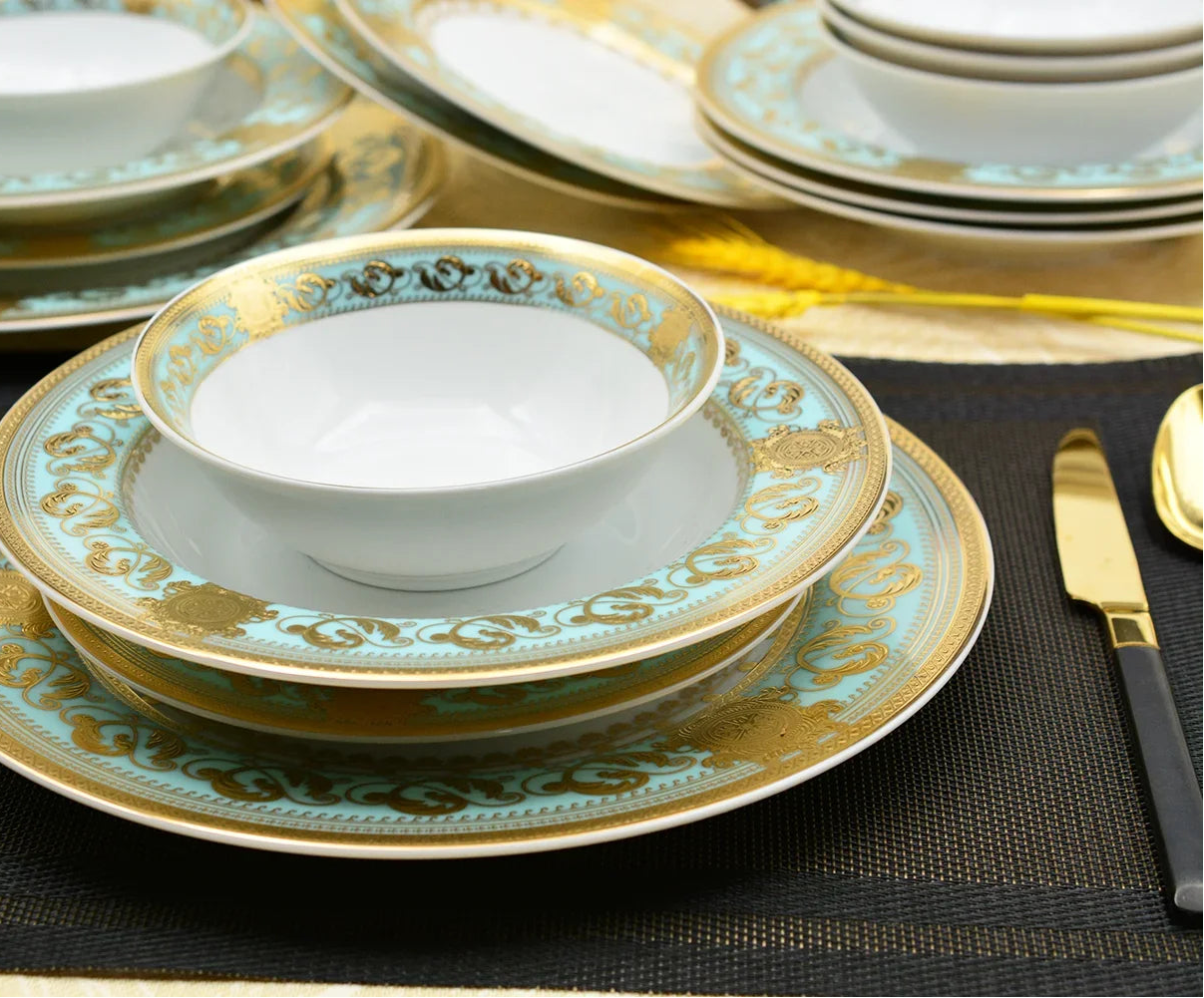Embossed gold porcelain dinnerware set by MC THE BLACK DIAMOND featuring elegant, luxury plates and bowls with intricate designs.