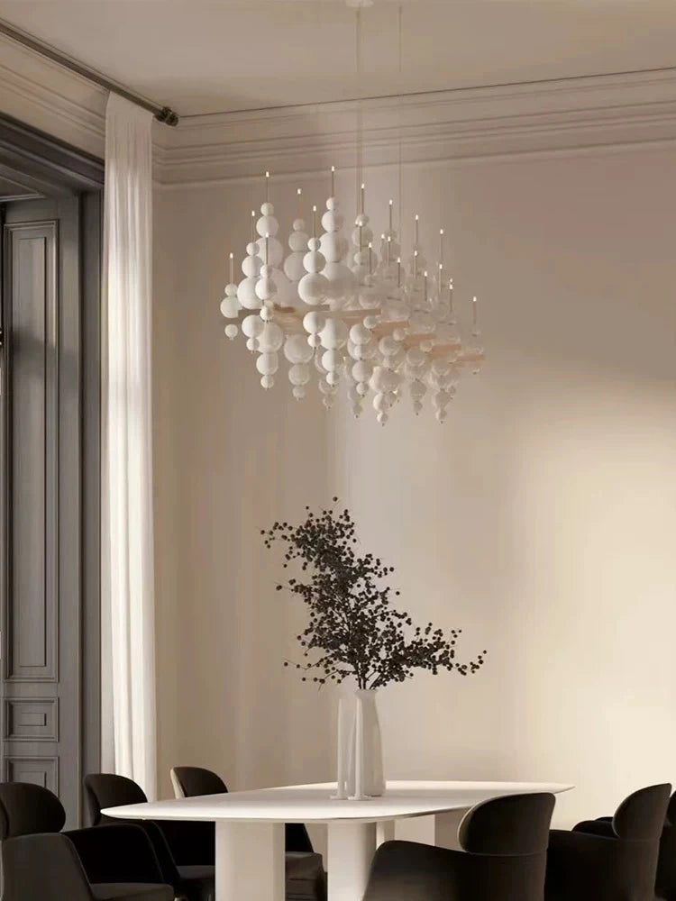 Black chandelier from MC THE BLACK DIAMOND, luxury living room lighting fixture with elegant design and multiple light bulbs.
