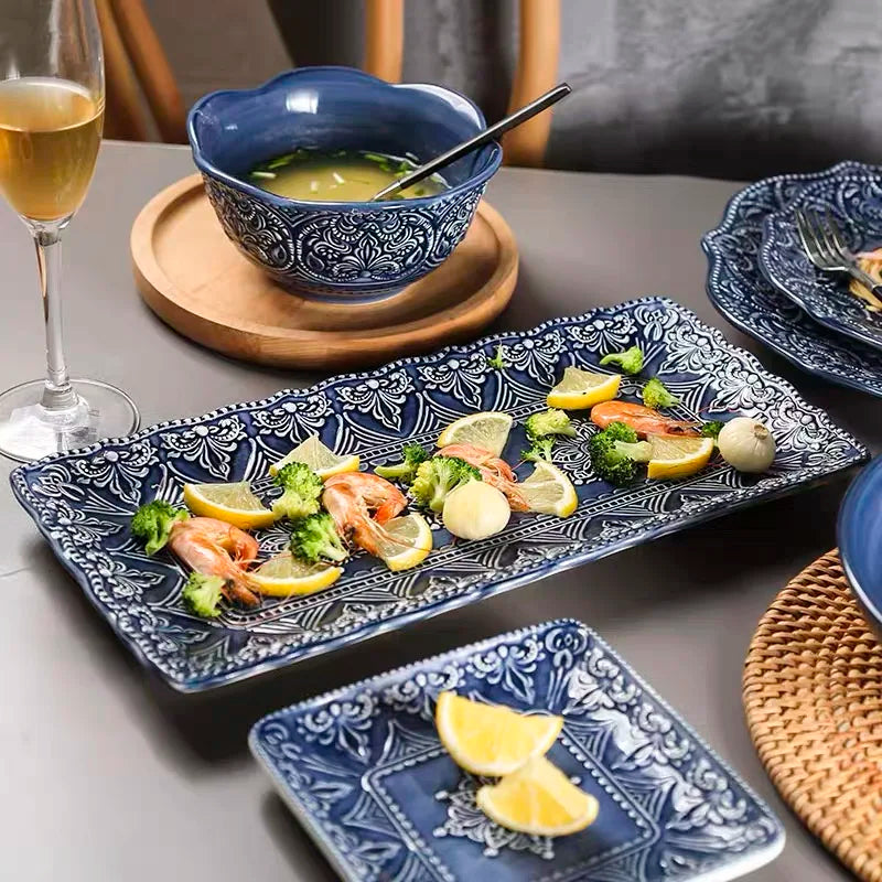Blue retro relief ceramic dinnerware set by MC THE BLACK DIAMOND, featuring matching plates and bowls with vintage-inspired design.