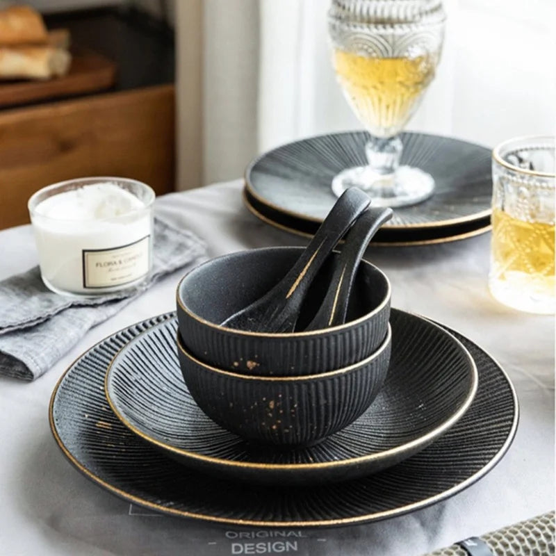 Luxury golden and black dinnerware set by MC THE BLACK DIAMOND, featuring elegant plates and bowls for sophisticated table settings.