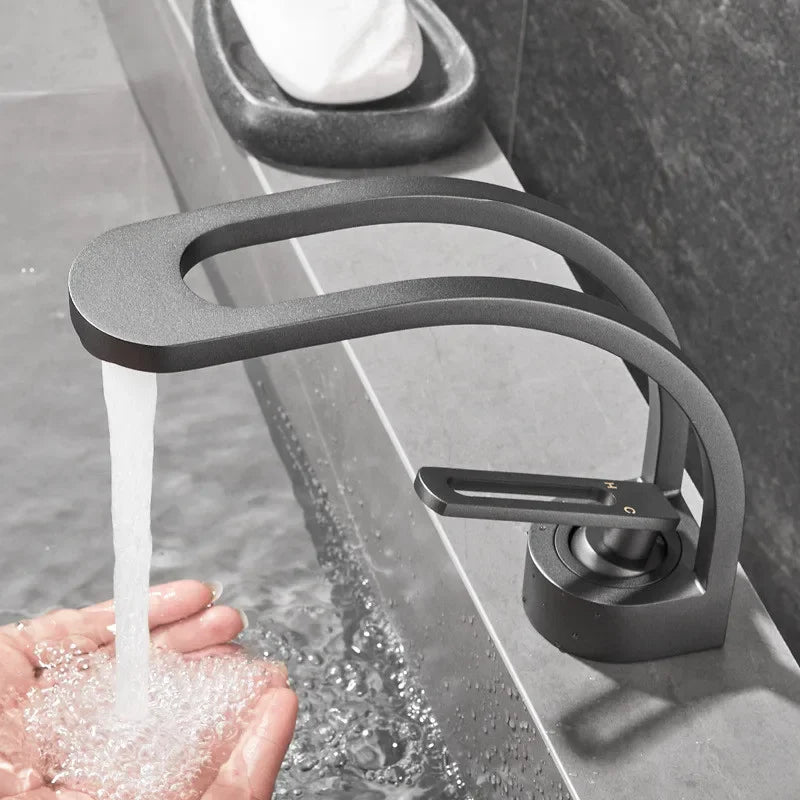 Single-handle MC THE BLACK DIAMOND bathroom basin faucet with modern design, mounted on a white bathroom sink.