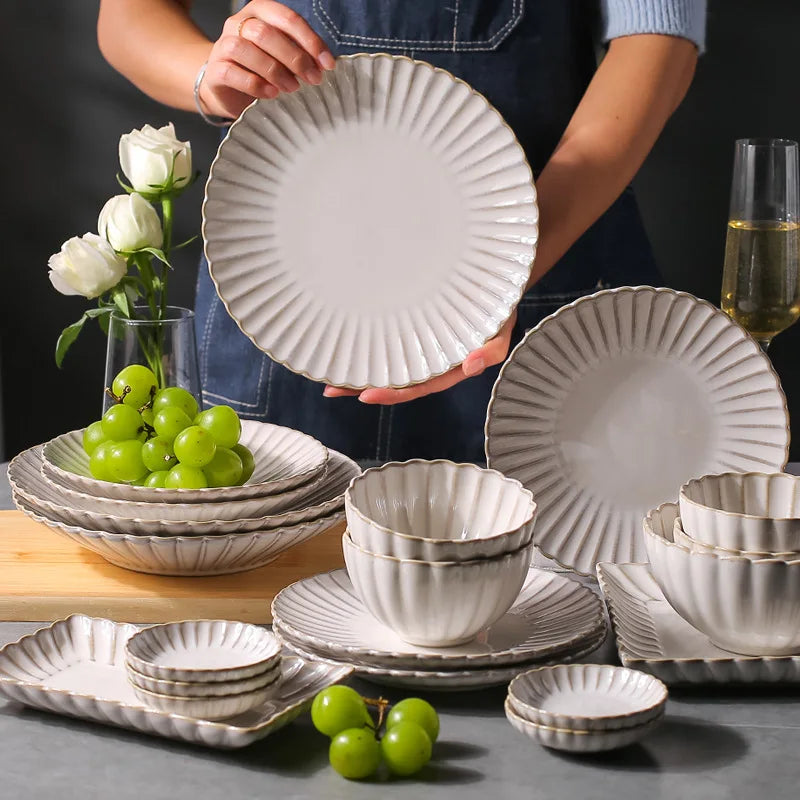 White chrysanthemum-shaped ceramic dinnerware set by MC THE BLACK DIAMOND, featuring elegant flower-shaped plates and bowls.