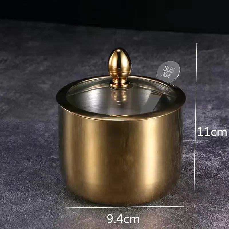 Golden seasoning box with glass cap and spoon, MC THE BLACK DIAMOND kitchen tool for flavoring and spice storage.