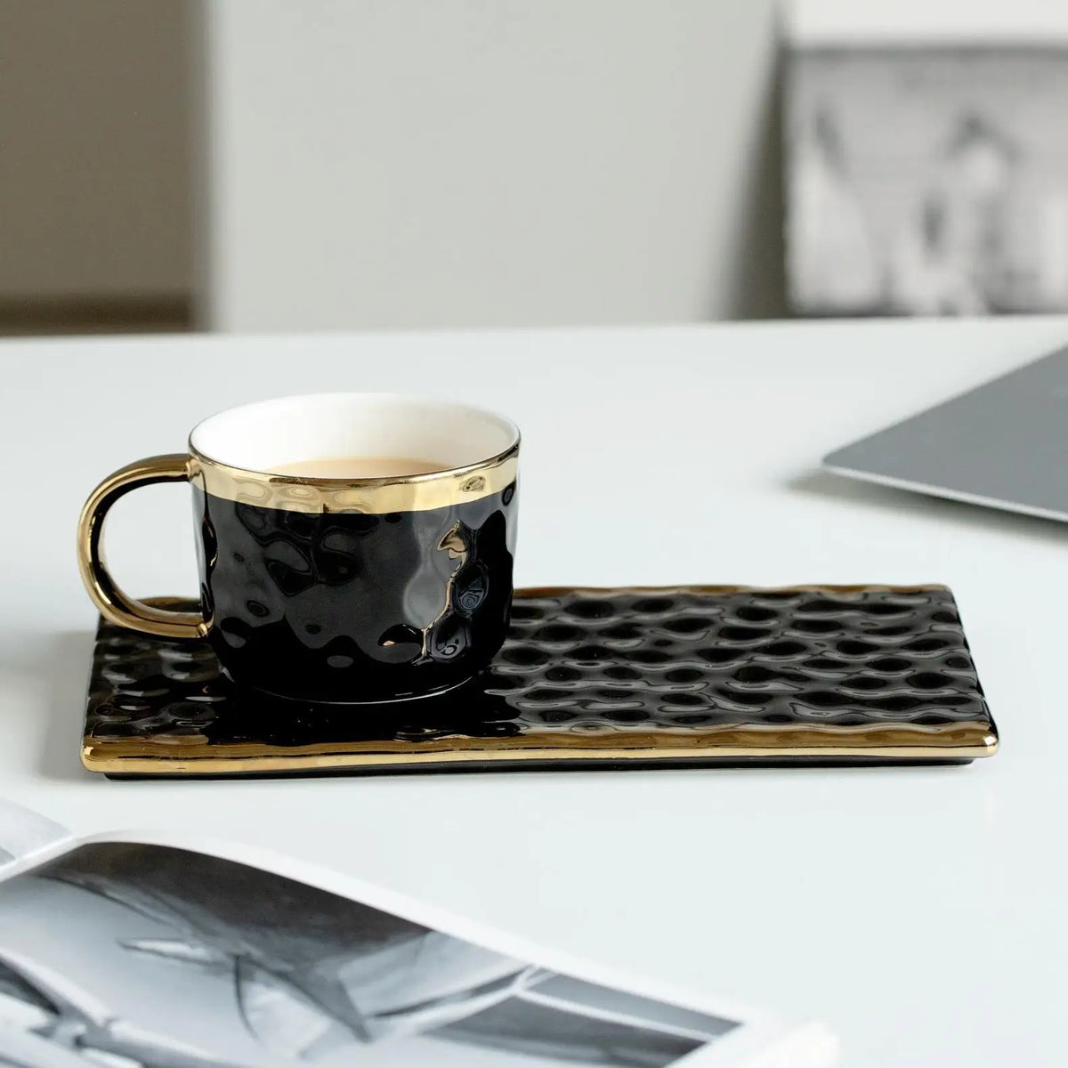 Set of MC THE BLACK DIAMOND coffee and tea mugs, including milk and afternoon tea cups, arranged on a table.