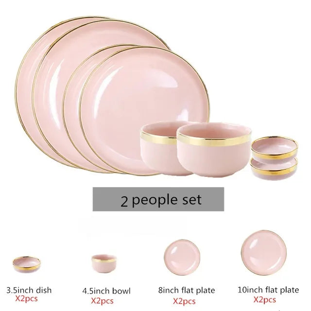Set of bright white and pink porcelain kitchen plates with gold accents by MC THE BLACK DIAMOND, arranged for display.