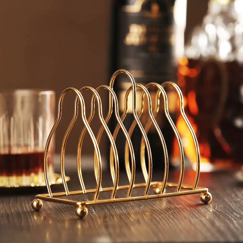 Golden metal cocktail coaster featuring classical design by MC THE BLACK DIAMOND, perfect for elegant drink presentation.