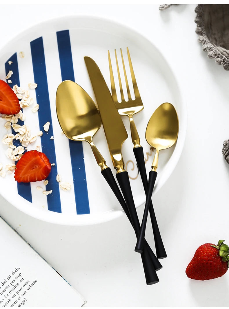 Matte stainless steel black, gold, and silver dinnerware set featuring reflective finishes and modern design for elegant dining.