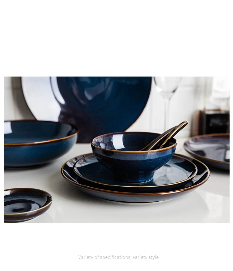 Deep blue ceramic dinnerware set by MC THE BLACK DIAMOND, featuring matching plates and bowls for elegant table setting.