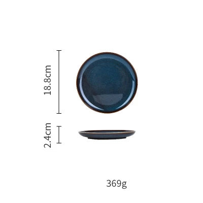 Deep blue ceramic dinnerware set by MC THE BLACK DIAMOND, includes plates and bowls with a sleek, glossy finish.