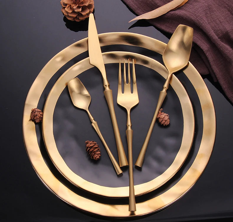 Mirror matte stainless steel black gold silver dinnerware set with reflective finish and elegant design, showcasing plates and utensils.