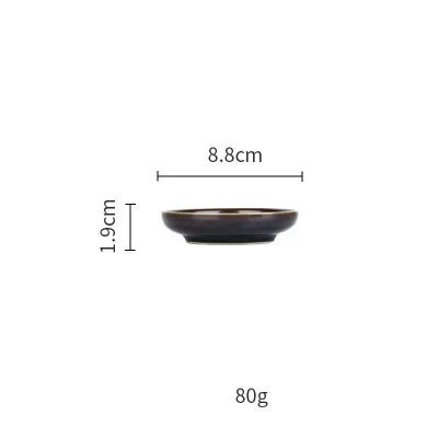 Deep blue ceramic dinnerware set by MC THE BLACK DIAMOND, featuring plates and bowls for elegant table setting.