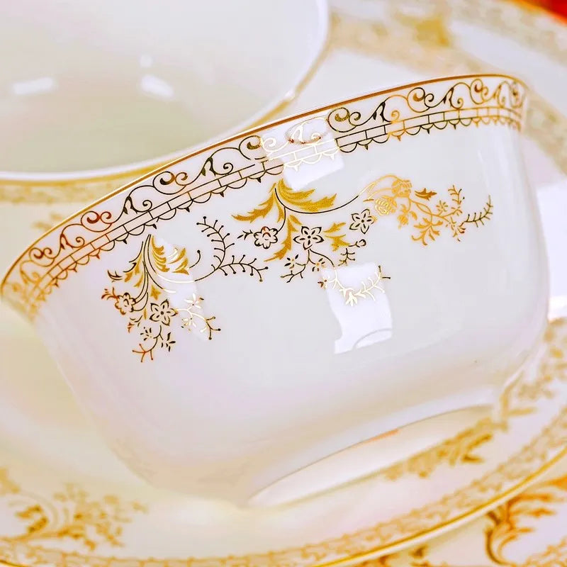 Family-size Royal Dinnerware Set by MC THE BLACK DIAMOND, includes plates, bowls, and cups with elegant gold accents on white porcelain.