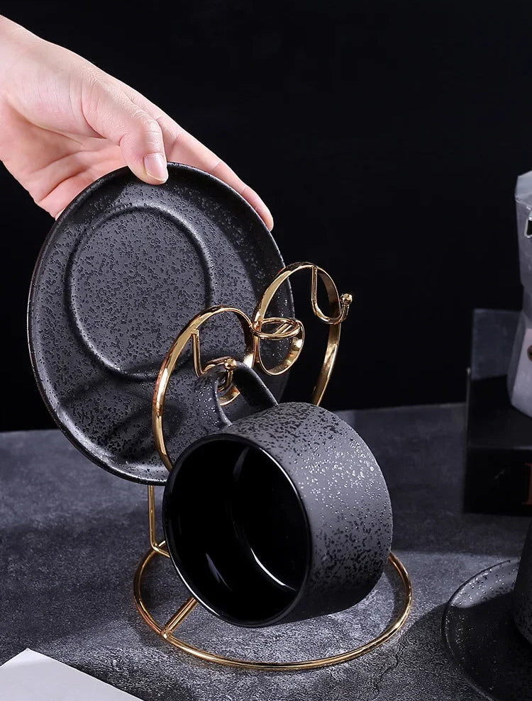 Black ceramic coffee cup and saucer set with spoon and cup holder, part of MC THE BLACK DIAMOND coffee and tea sets.