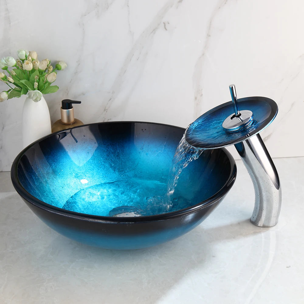 Blue glass vessel sink with waterfall faucet set by MC THE BLACK DIAMOND, featuring a sleek, modern design and smooth glass finish.