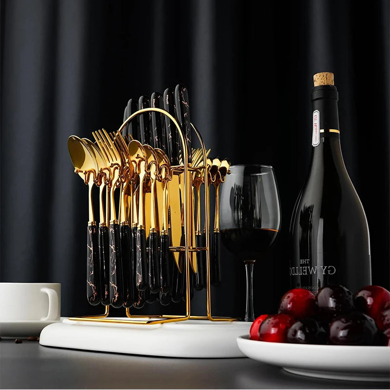 Stainless steel flatware set with knives, forks, and spoons from MC THE BLACK DIAMOND, arranged on a dining table.