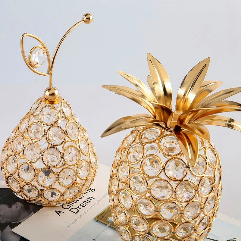 Gold crystal pineapple tabletop centerpiece for home decor by MC THE BLACK DIAMOND, featuring a shiny, decorative pineapple design.
