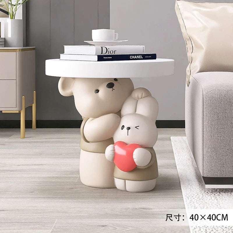 Cream-colored MC THE BLACK DIAMOND bear statue on a coffee table, designed as a parent-child bear decor piece for home interiors.
