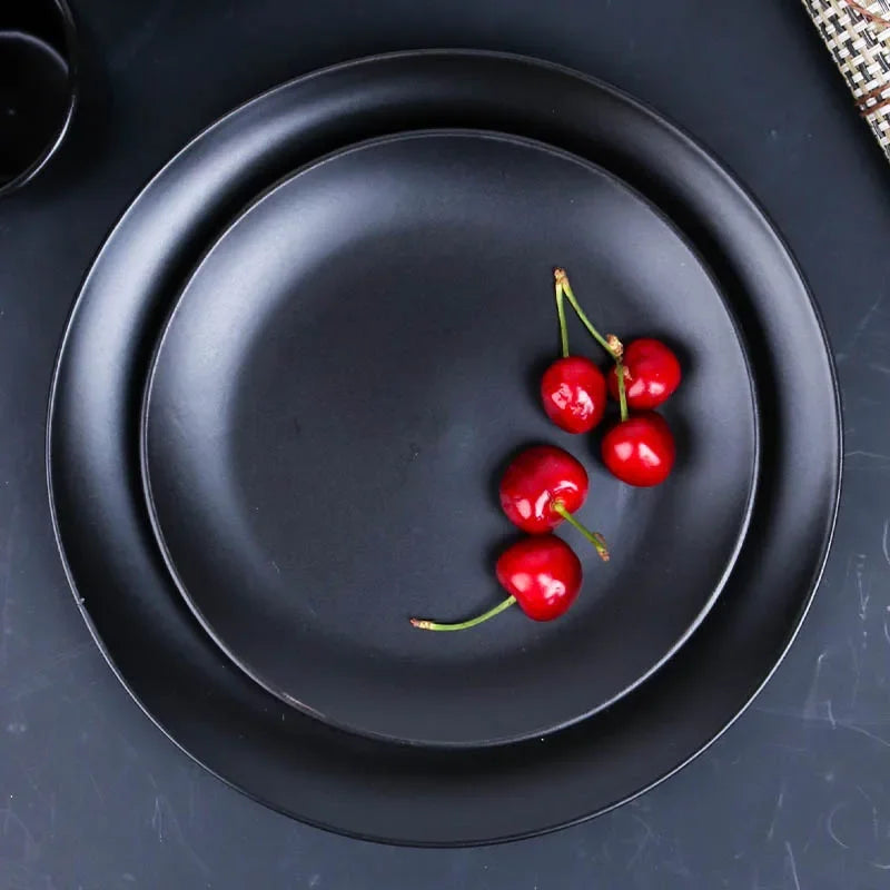 Deep black family dinnerware set by MC THE BLACK DIAMOND, includes plates, bowls, and cups for a stylish dining experience.