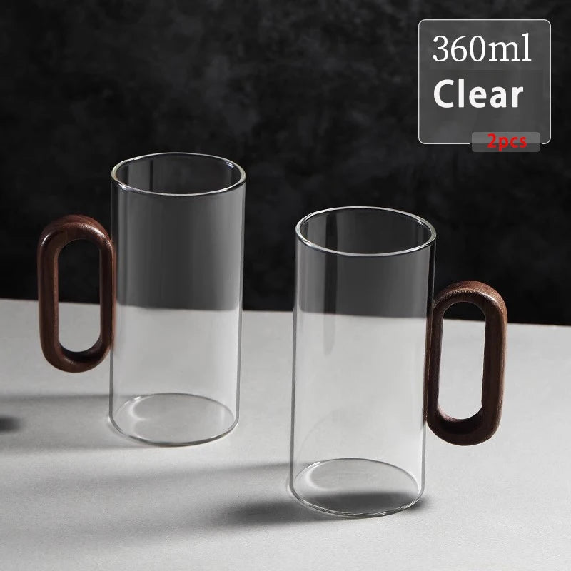 Glass mug with wooden handle from MC THE BLACK DIAMOND drinkware set, showcasing a clear glass mug with a wooden handle for hot beverages.