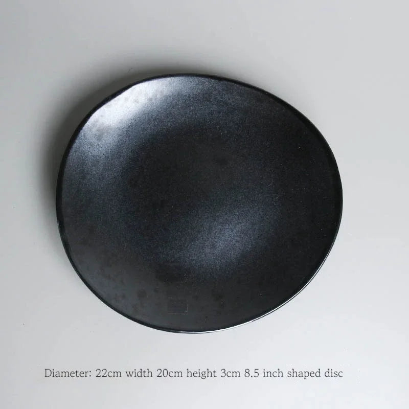 Deep black dinnerware set by MC THE BLACK DIAMOND featuring plates, bowls, and cups for family dining.
