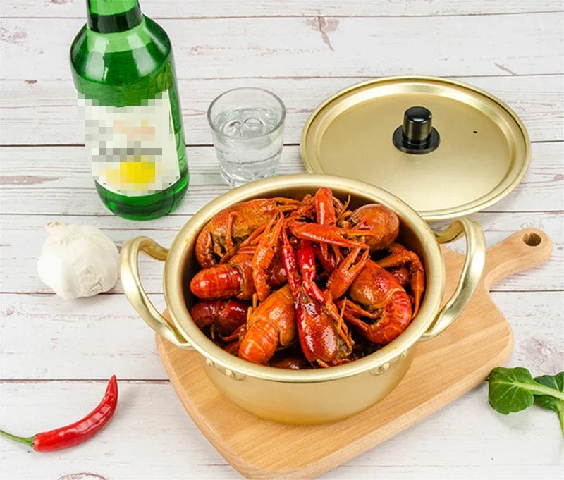 Gold aluminum stock pot from MC THE BLACK DIAMOND, ideal for cooking in the kitchen with durable aluminum construction.