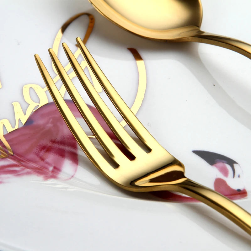 MC THE BLACK DIAMOND Golden Cutlery Flatware Set with stylish dishes, featuring sleek handles and polished gold finish for elegant dining.