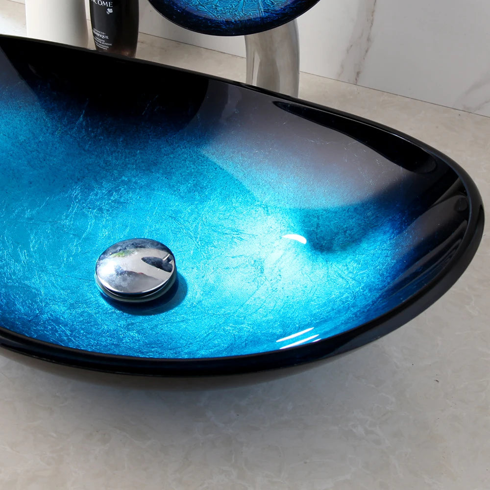 Blue glass vessel sink with waterfall faucet set by MC THE BLACK DIAMOND, showcasing a modern bathroom fixture with sleek design.